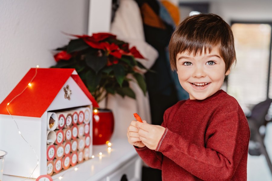Little Happy Child Opening First Day In Handmade Advent Calendar. Sustainable Christmas, Upcycling,