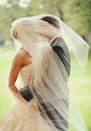bride and groom wrapped in her veil-4734 fe8b5